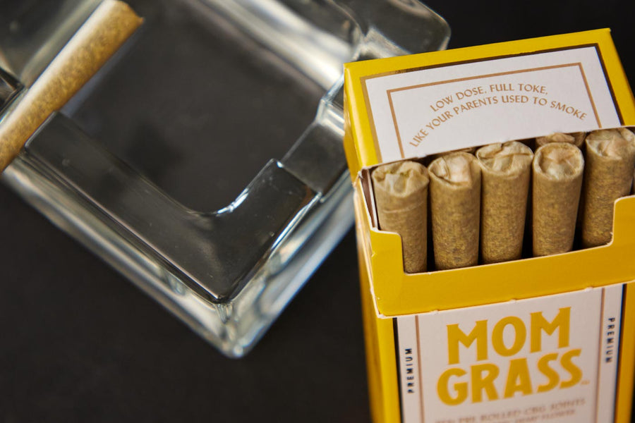 10 CBG Hemp Pre rolls in a Yellow Mom Grass pack with a glass ashtray