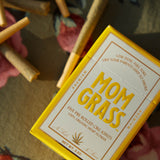 Mom Grass hemp cbg joints and hemp CBG pre roll 5 pack box on a floral tablecloth