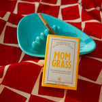 Mom Grass hemp CBG preroll 5 pack with a hemp flower joint in a ashtray