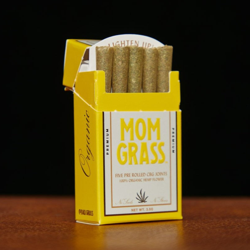 Mom Grass CBG pre rolls: yellow 5 pack box ope showing pre rolled CBG joints