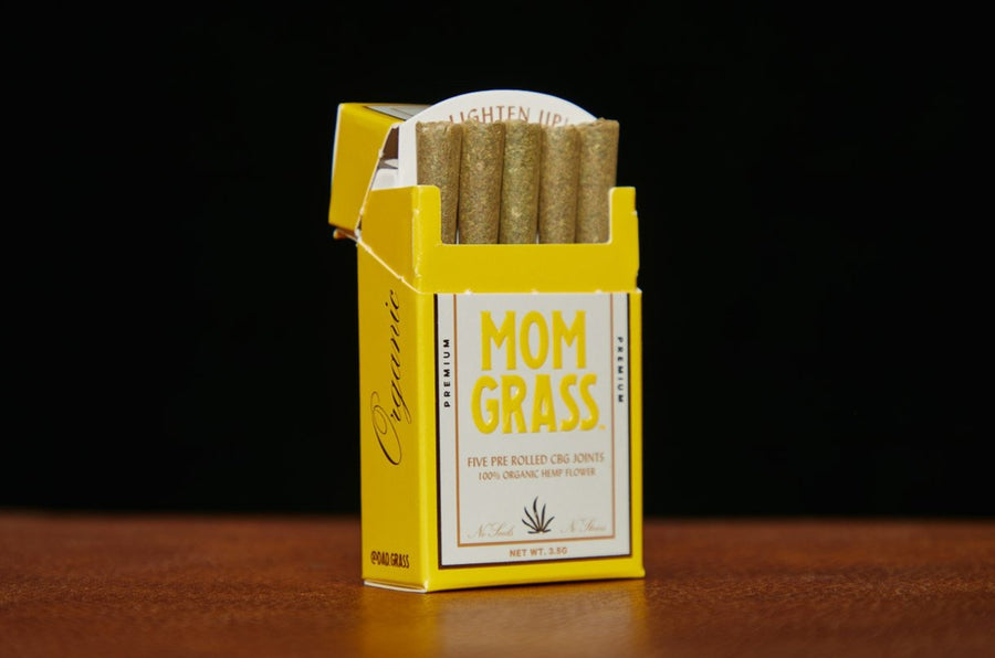 Mom Grass CBG pre rolls: yellow 5 pack box ope showing pre rolled CBG joints