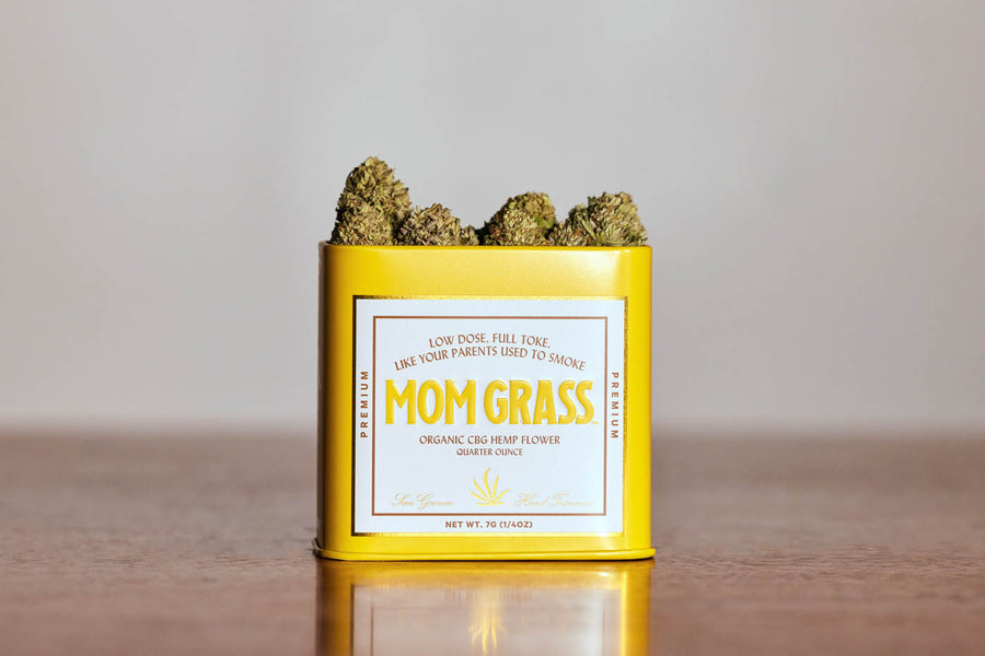 CBG Hemp Flower Coming Out From A Yellow Tin