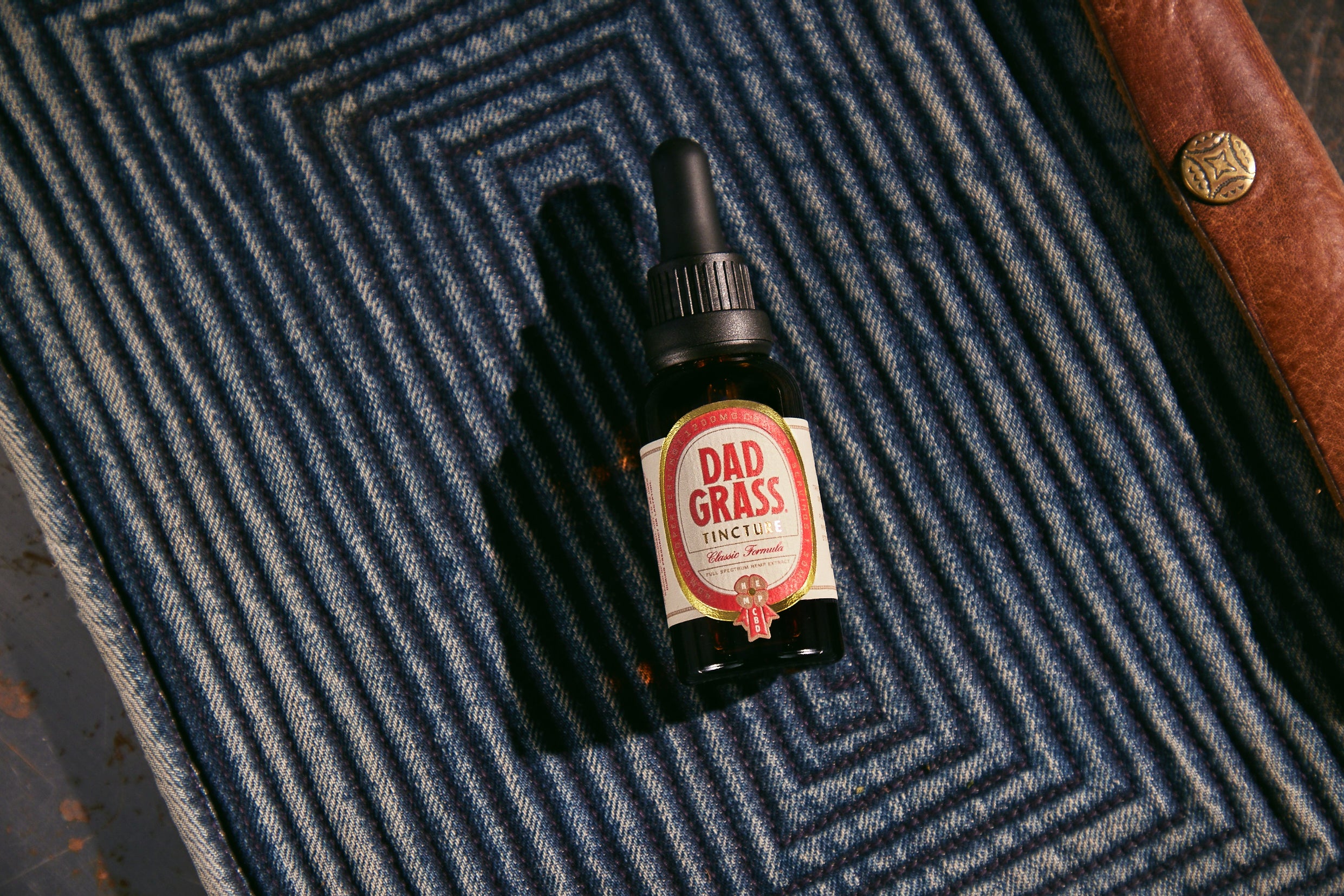 Dad Grass CBD Tincture Classic Formula 30 ML Bottle With 1200 MG Of CBD On A Carpet