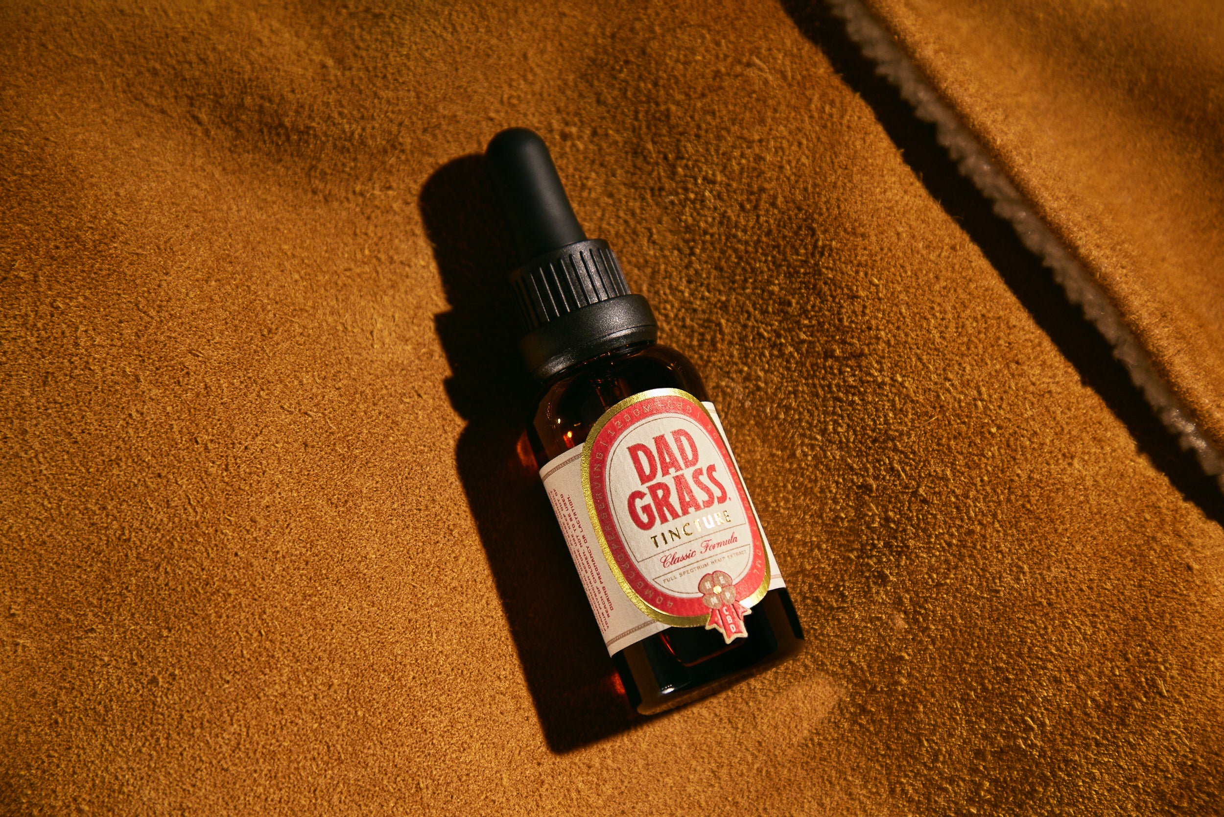 Dad Grass CBD Tincture Classic Formula 30 ML Bottle With 1200 MG Of CBD On A Brown Carpet
