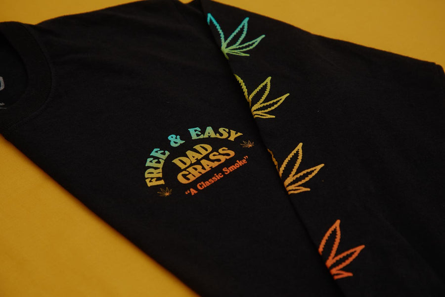 Unisex Black LS Tee With Dad Grass x Free & Easy And Hemp Leaves Printed On It Folded Close Up