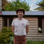 Man Wearing Dad Grass "Daddy Chill" Pride Tshirt - Front View