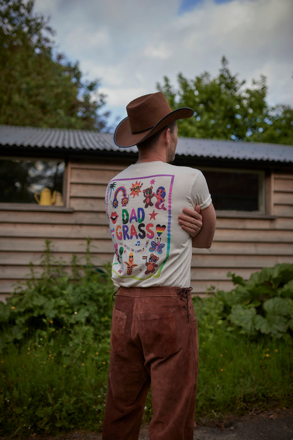 Man Wearing Dad Grass "Daddy Chill" Pride Tshirt - Back View
